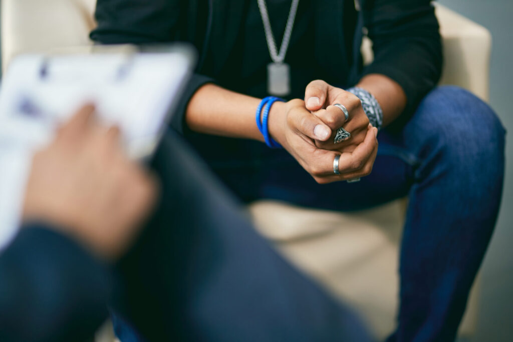 Close-up of black adolescent on therapy session with psychologist.